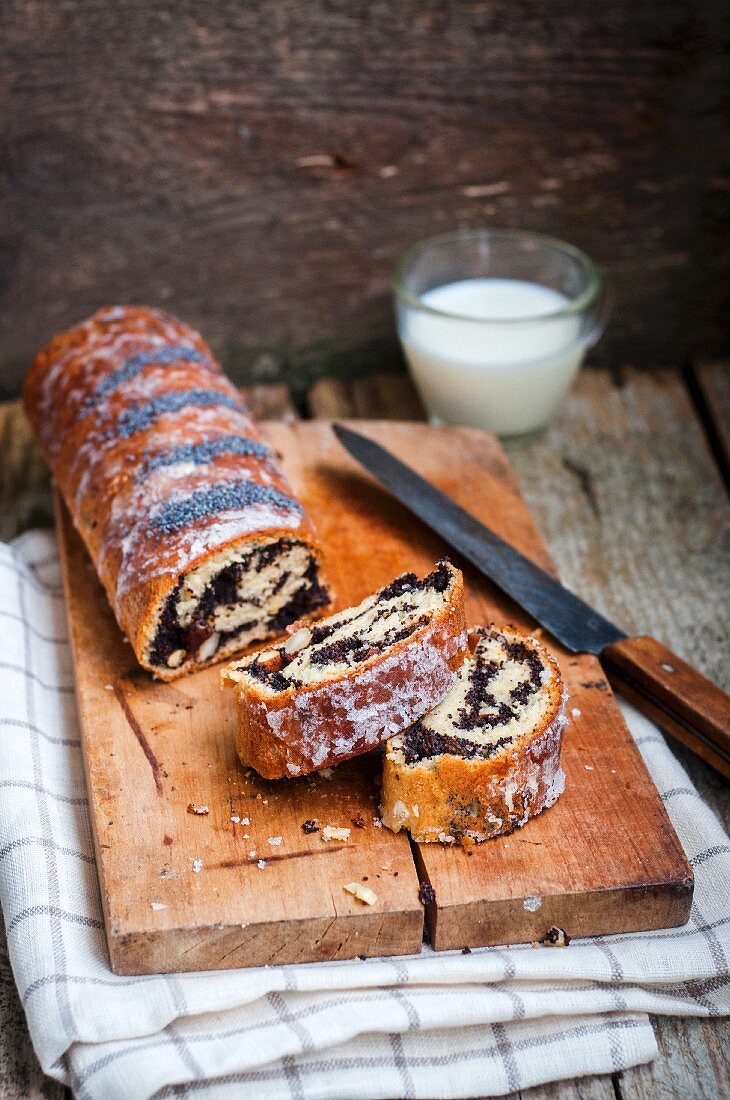 Poppy seed roulade, sliced, ​​on a wooden board