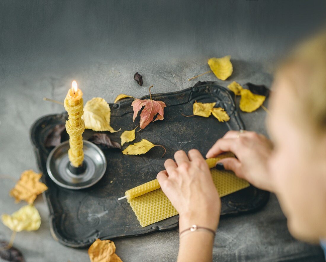 Hand-rolling candles from a beeswax sheet