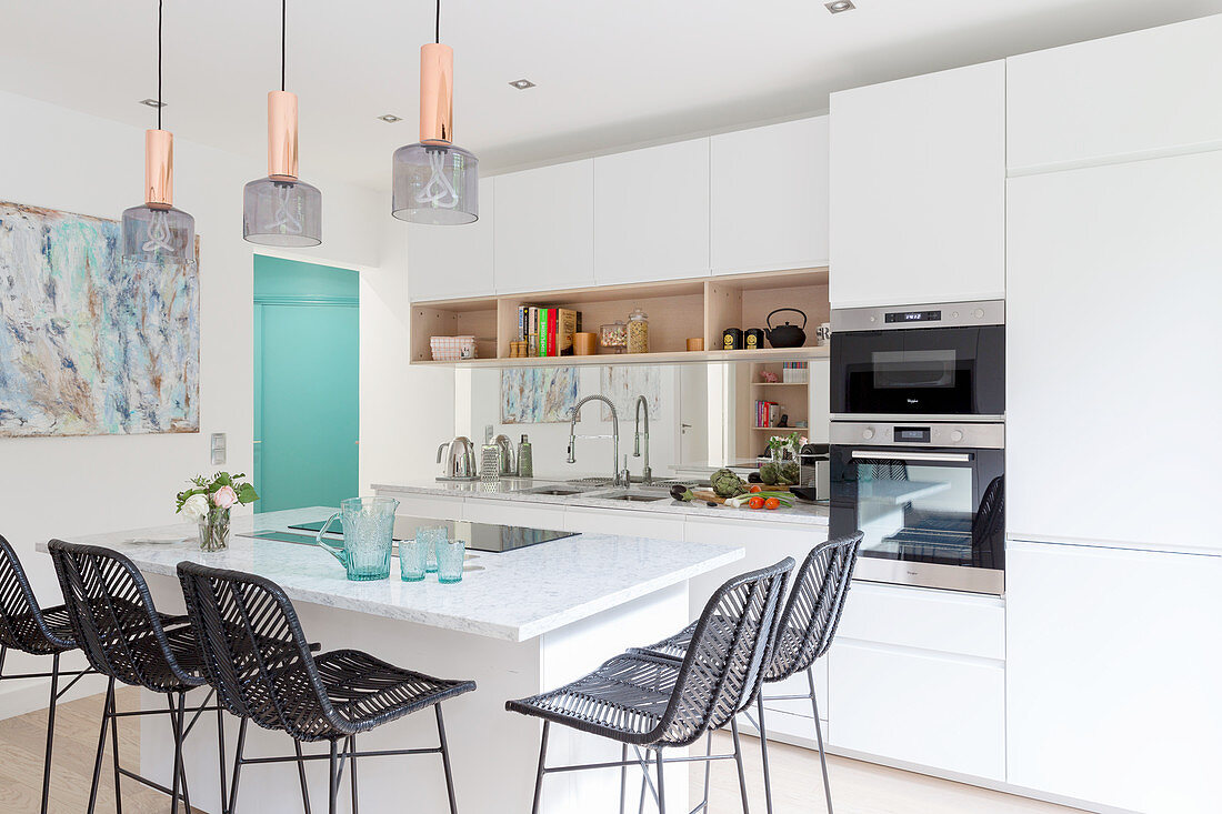 Black barstools at island counter in open-plan kitchen