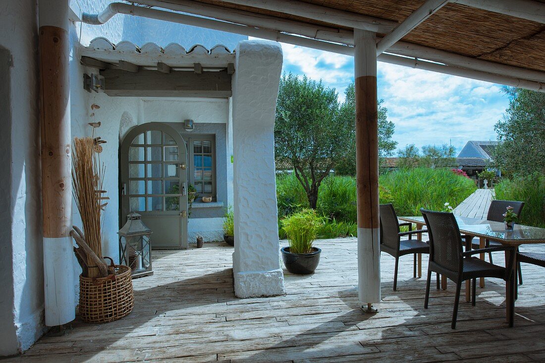 Table and chairs on terrace of Mediterranean house