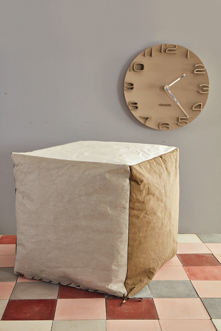A cube seat made of vegan leather paper
