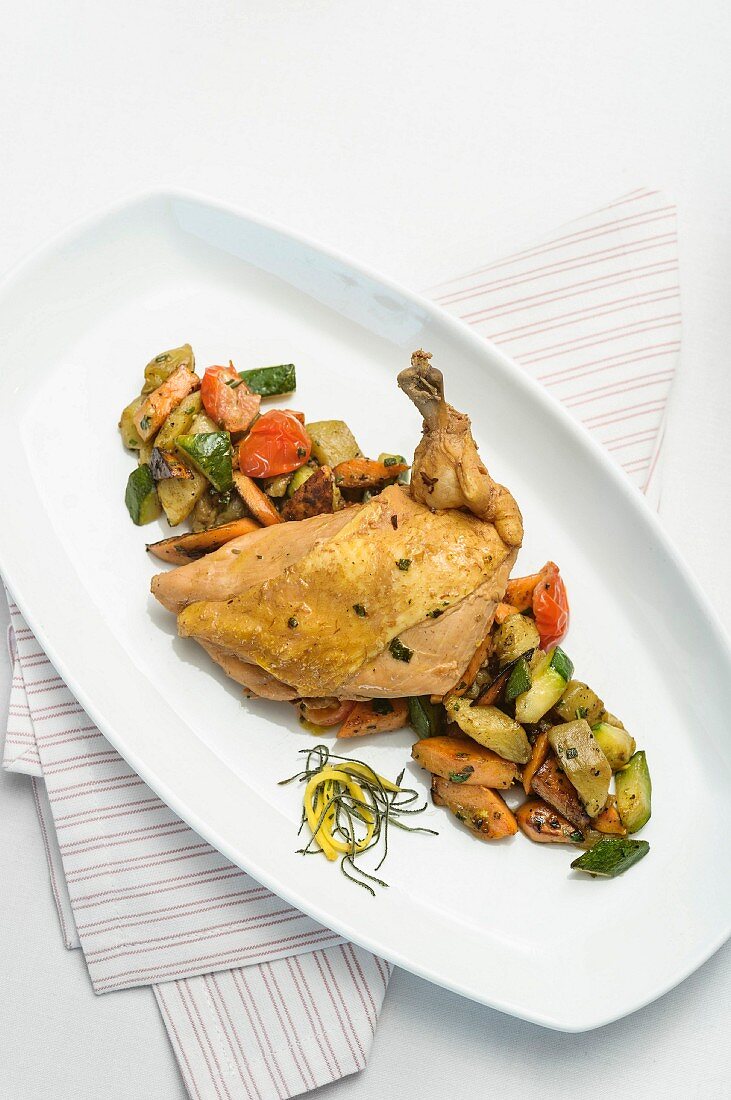 A poached guinea fowl breast with sweet potato and vegetables
