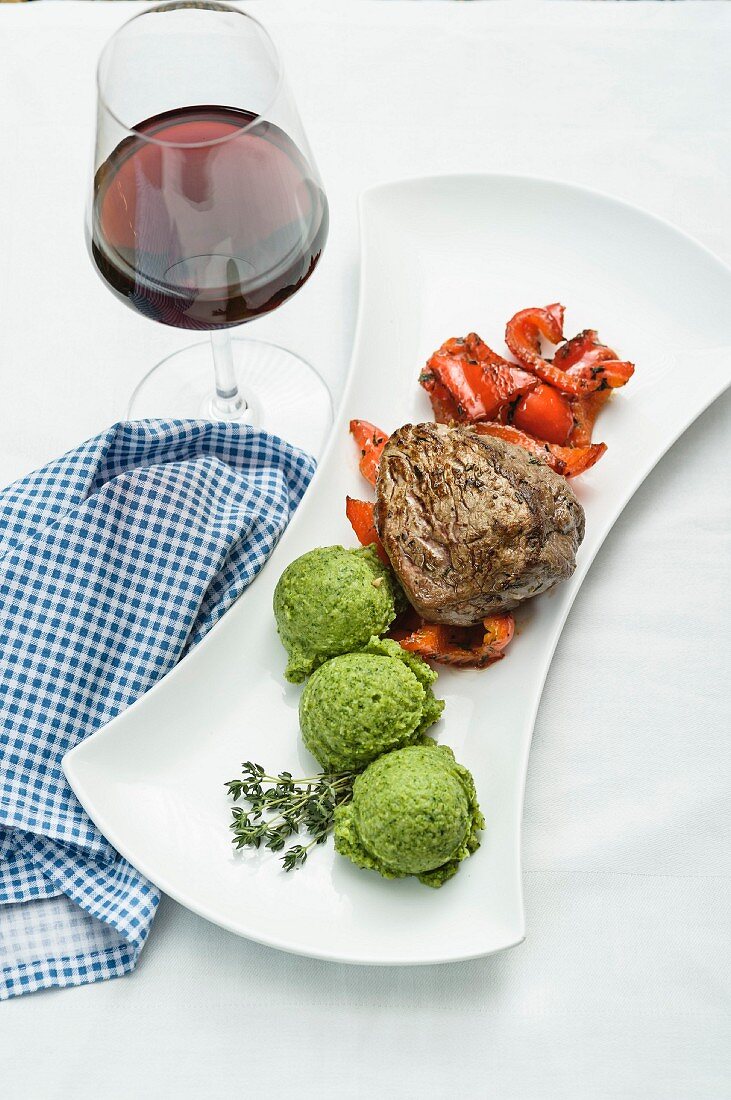 A pink roast beef fillet with thyme infused peppers and broccoli mousse