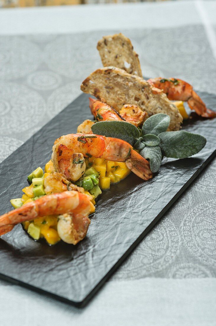 King prawns fried in sage oil with an avocado and mango salad