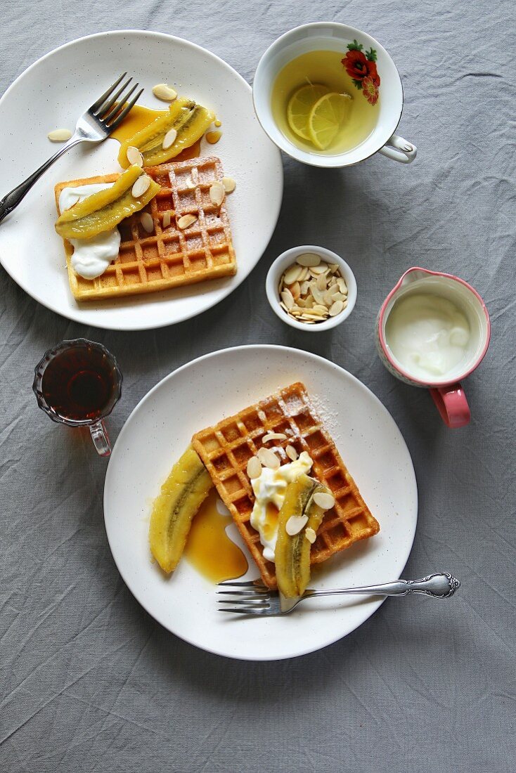 Waffles with caramelized bananas, yogurt and toasted almond flakes