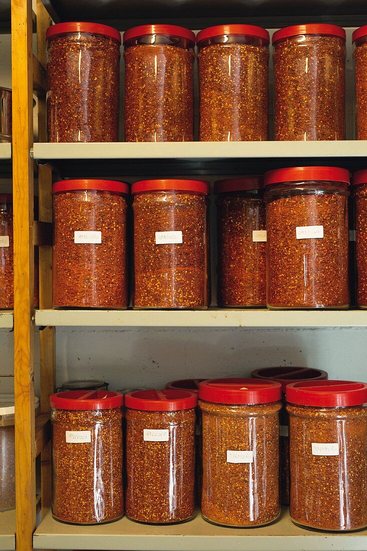 Jars of crushed chilli peppers in a Benedictine monastery near Siena, Tuscany, Italy