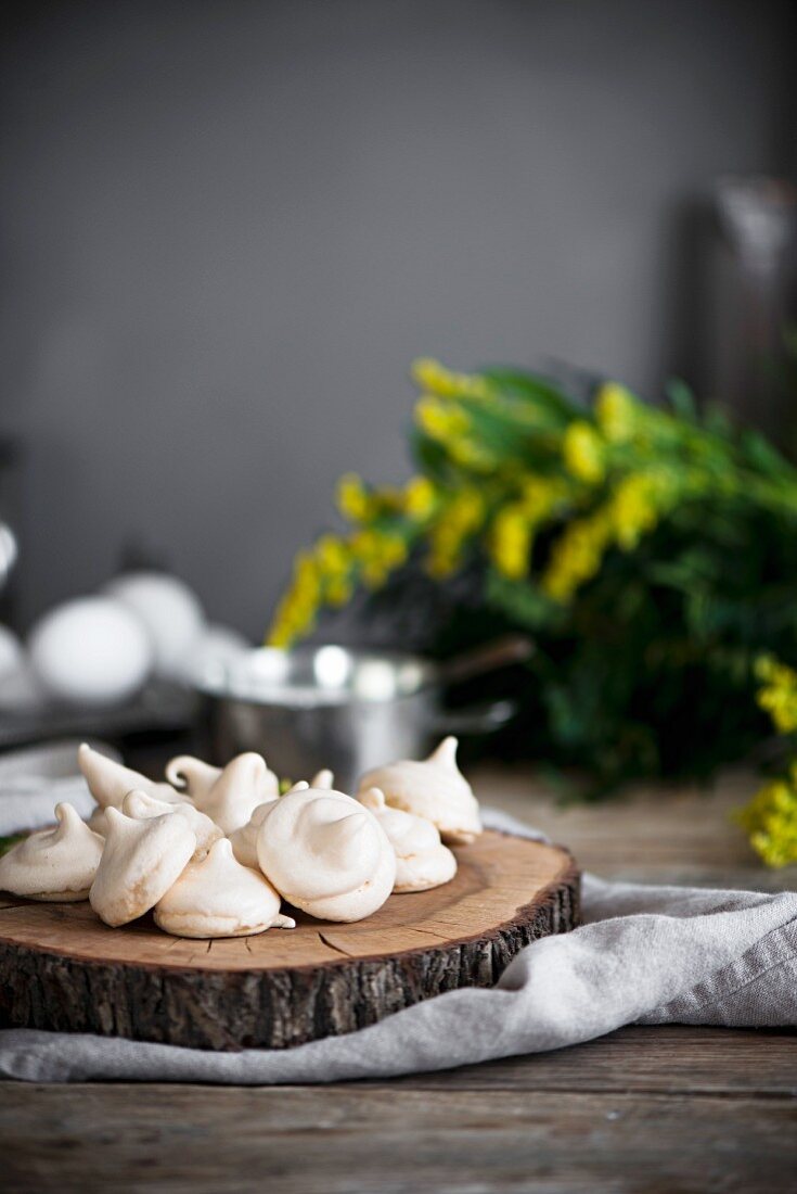 Mini meringues on a slice of tree trunk