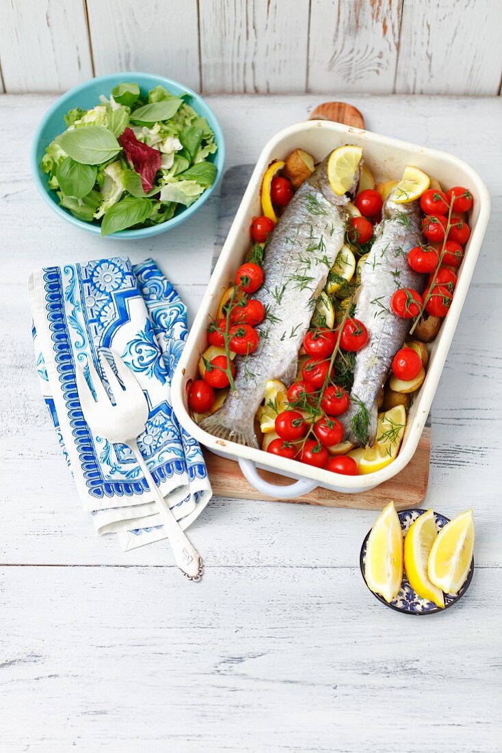 Oven baked trout with cherry tomatoes and potatoes