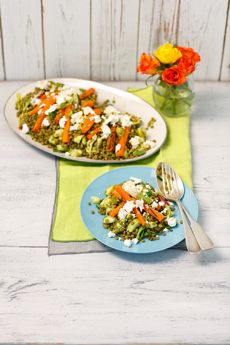 A lentil salad with green lentils, carrots, avocado and feta