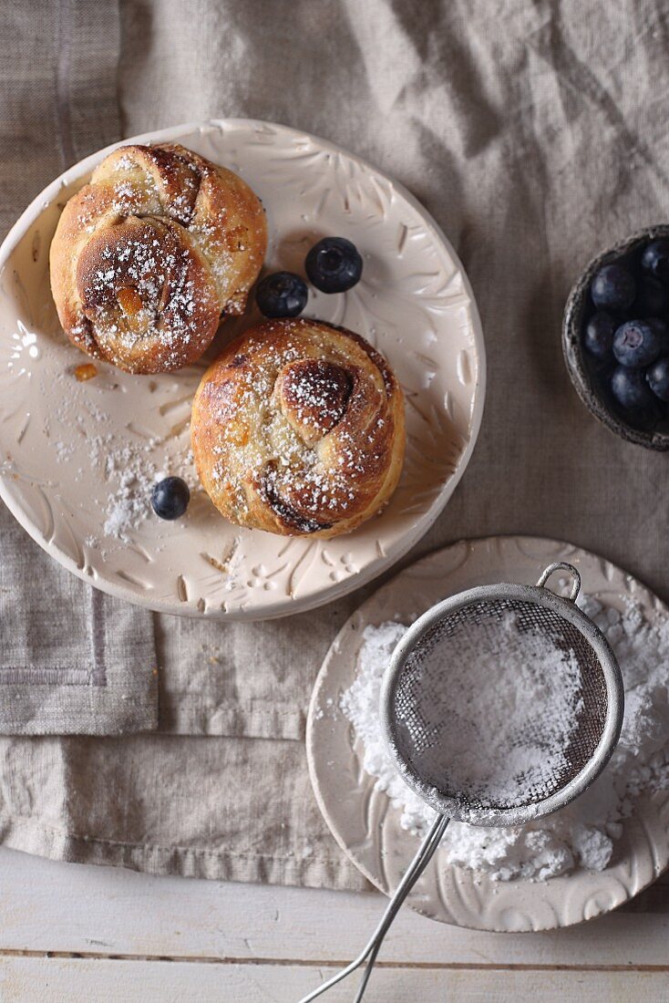 Orange brioche with chocolate, powdered sugar, and blueberries