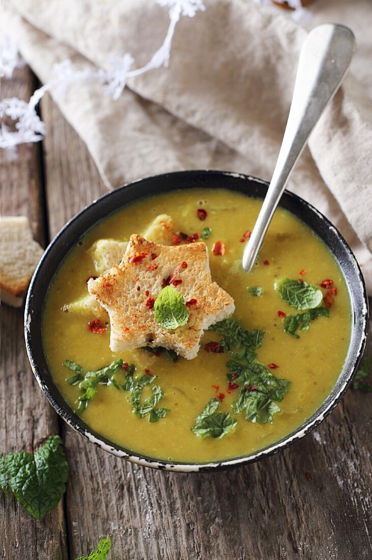Red lentil soup with turmeric, mint, and toasted bread stars