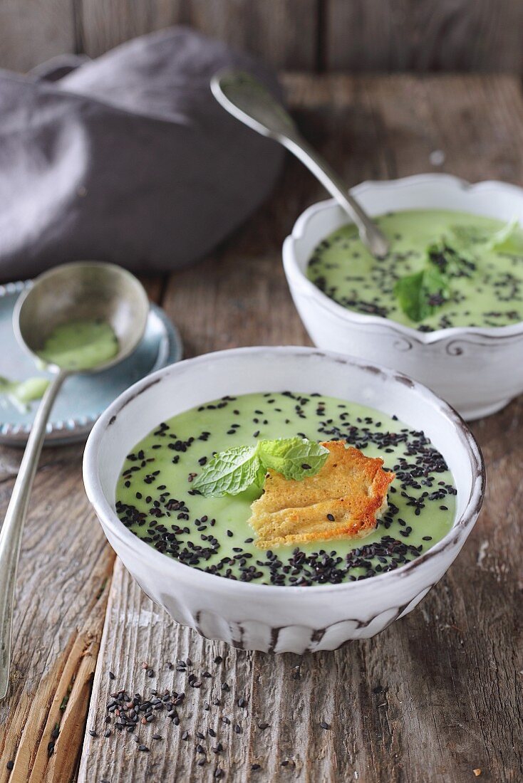 Pea soup with cheese crisps and black sesame seeds