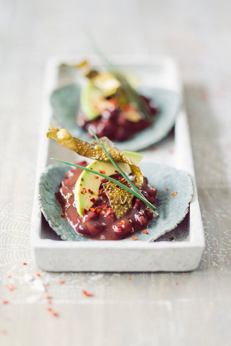 Blue tacos with bean chilli and algae bacon