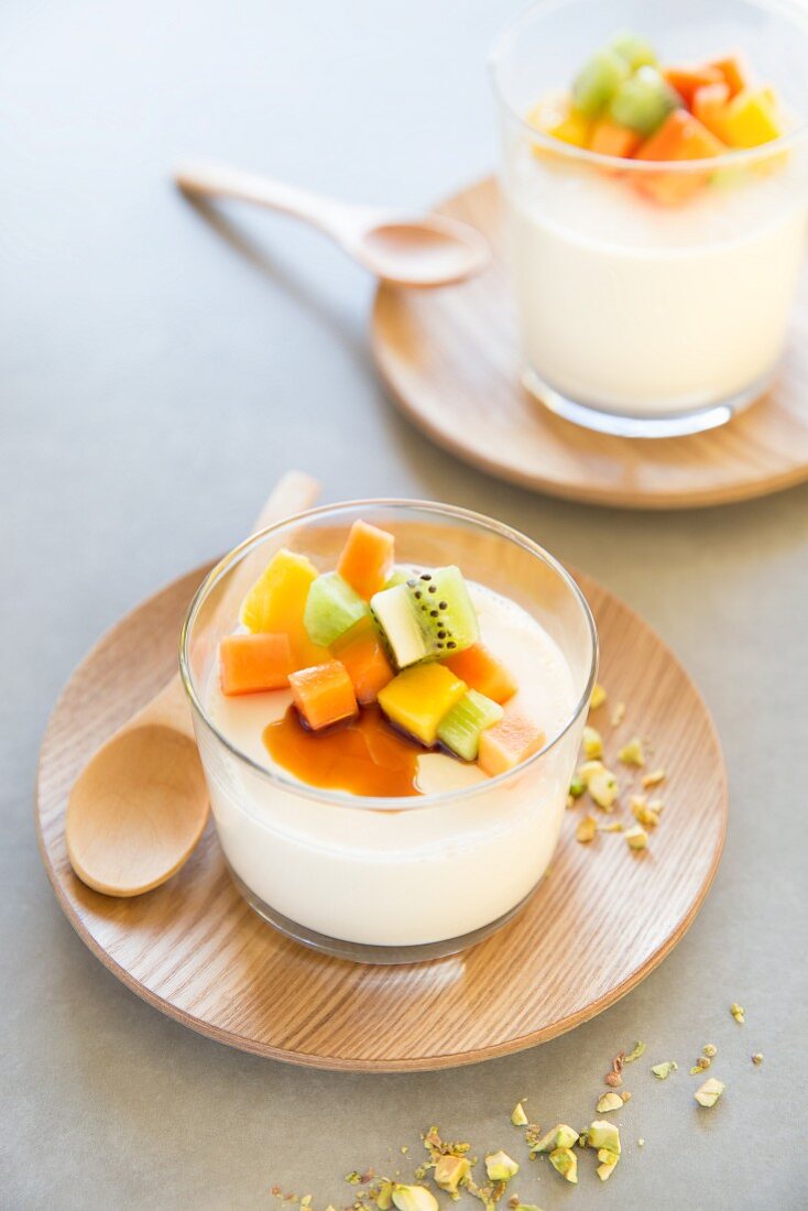 Panna cotta with exotic fruits, honey and pistachios