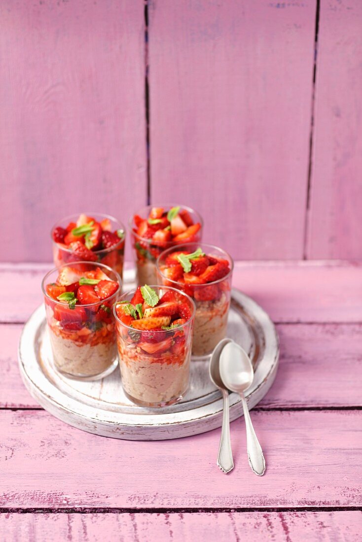 Chocolate millet pudding with strawberries in dessert glasses