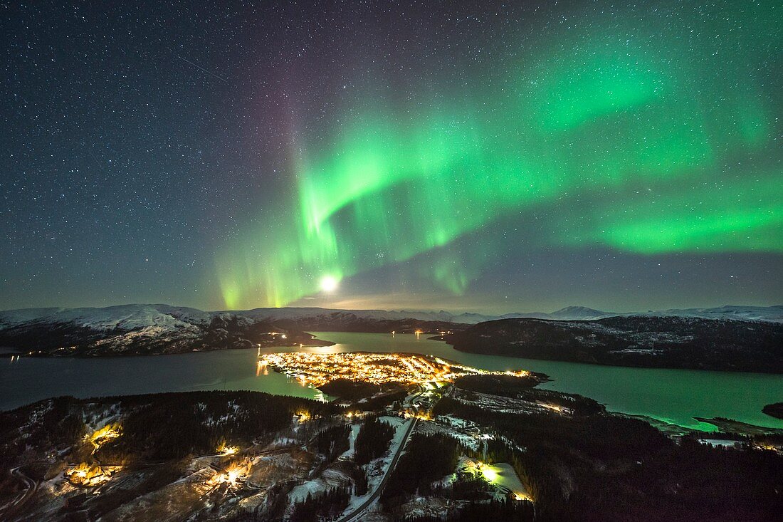 Aurora borealis over city lights