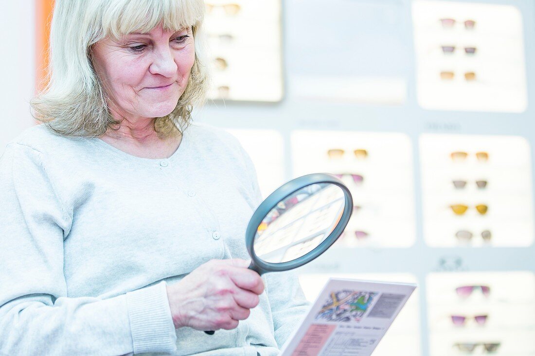 Senior woman holding magnifying glass