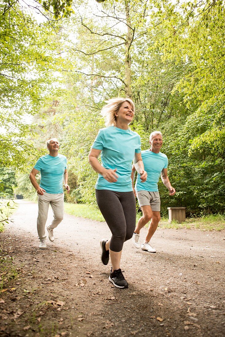 Three senior people running, smiling