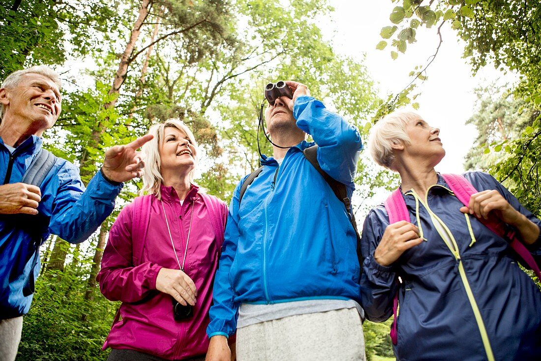 Four people on hike with binoculars