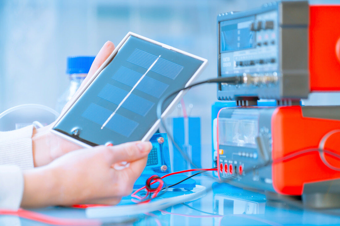 Scientist with solar fuel cell in laboratory