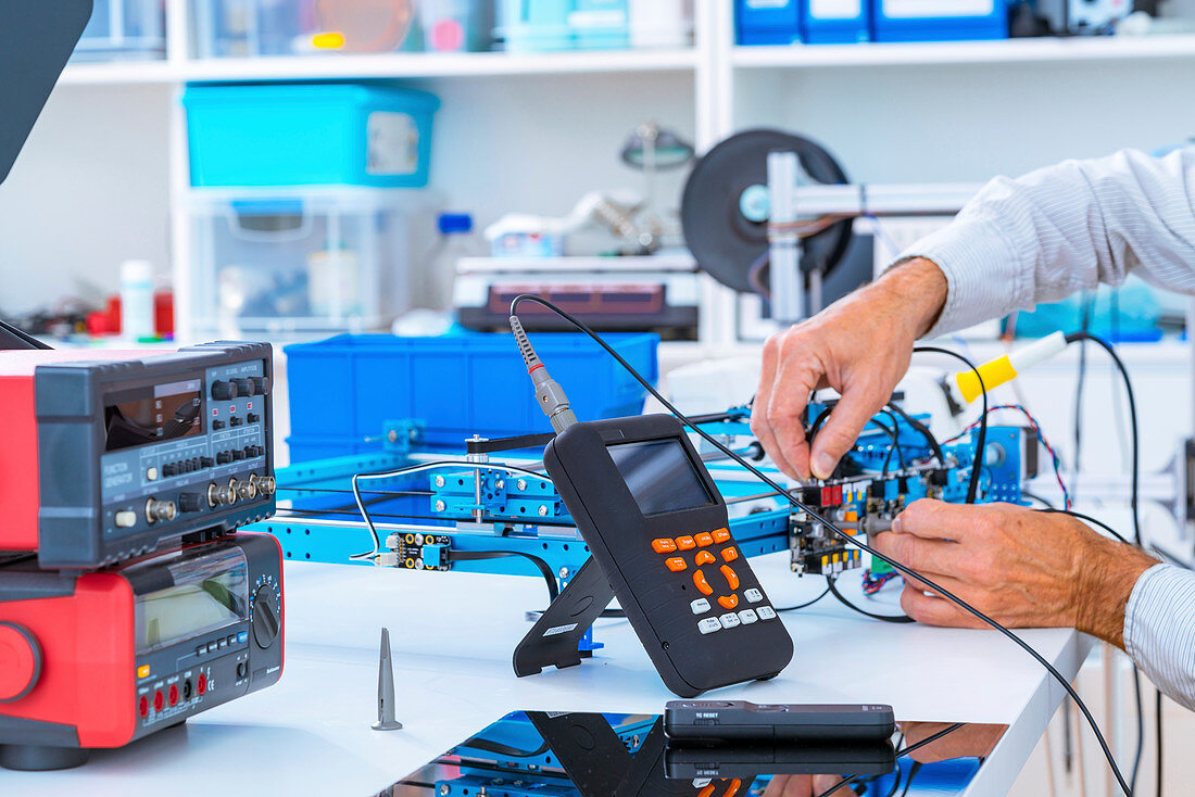 Person working in electronics laboratory