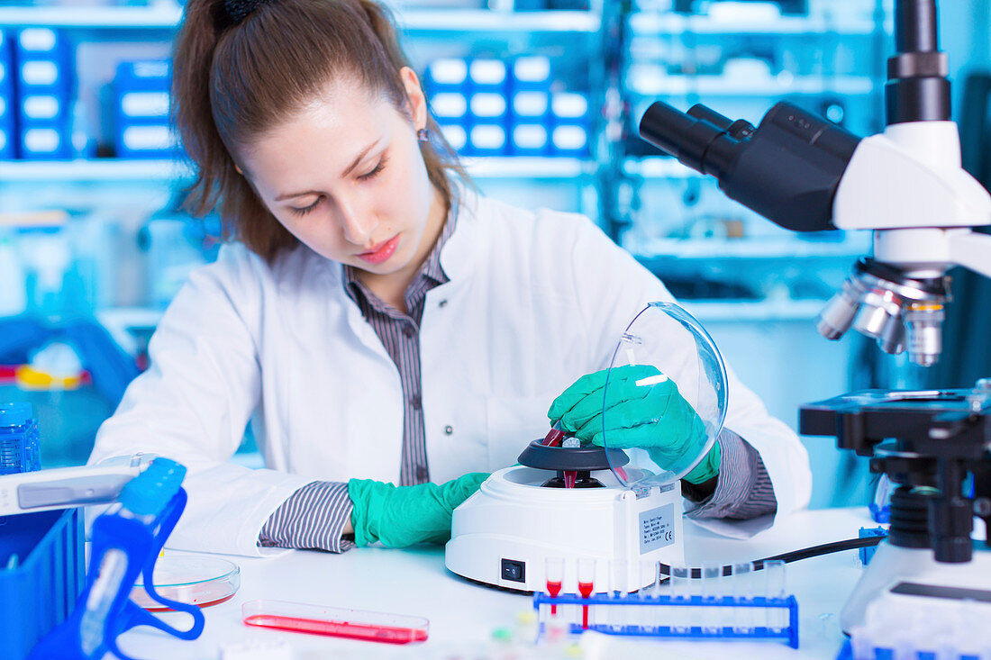 Scientist using a centrifuge