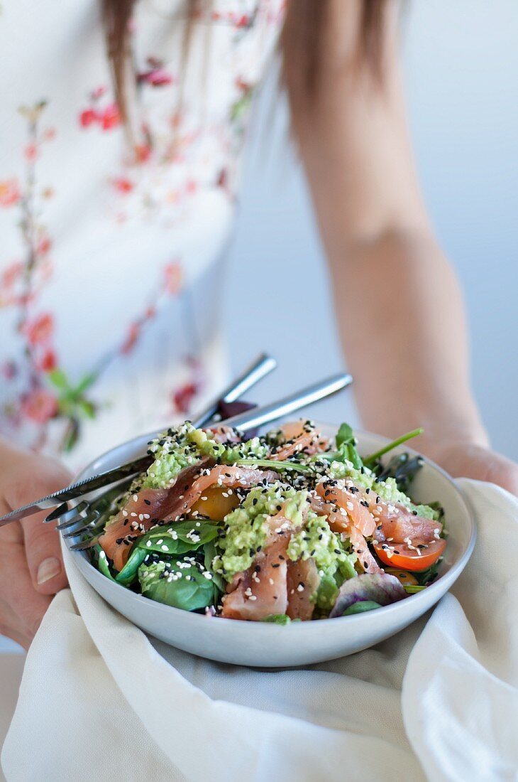 Avocado and salmon salad with sesame seeds