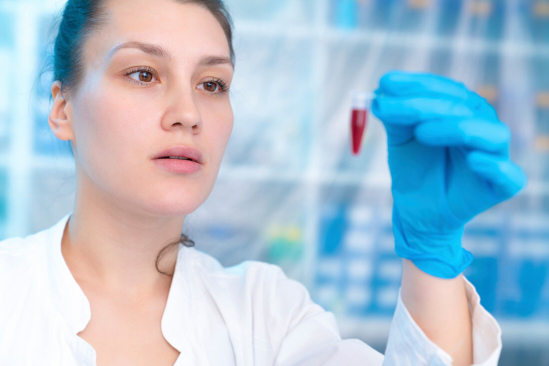Scientist holding eppendorf tube in laboratory