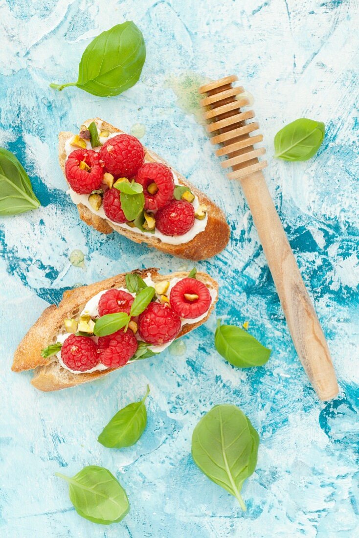 Crostini with ricotta, raspberries, pistachios and basil