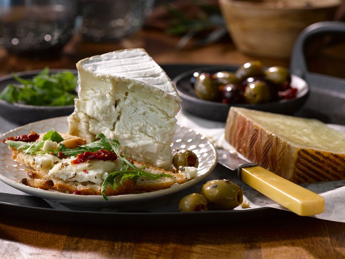 A cheese plate with olives