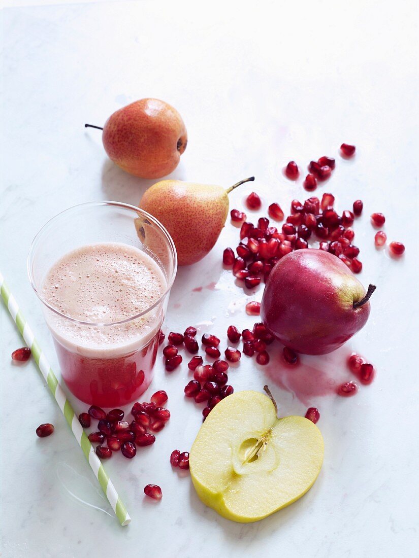 Apple and pear juice with pomegranate seeds