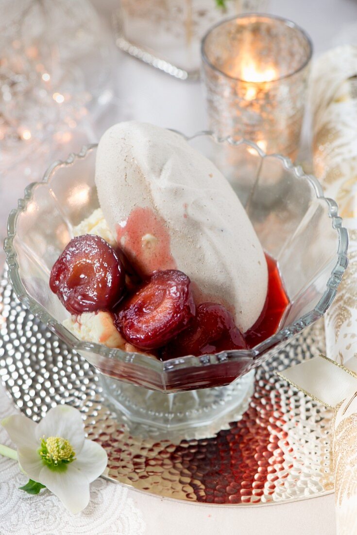 A meringue with cream and balsamic plums as a festive dessert