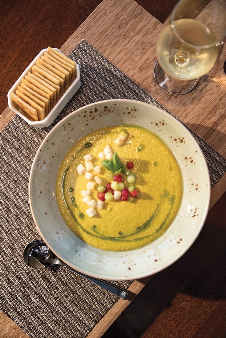 Yellow tomato gazpacho with crackers and white wine