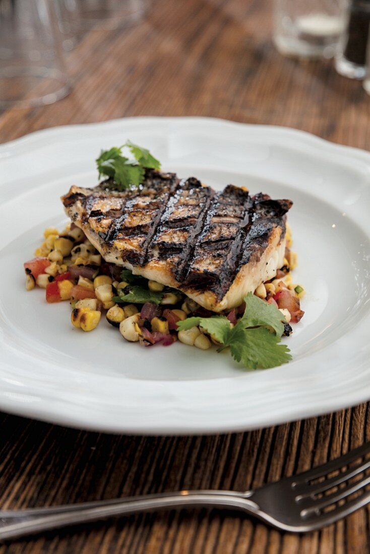 Sea bass with charred corn, onion and tomato salad