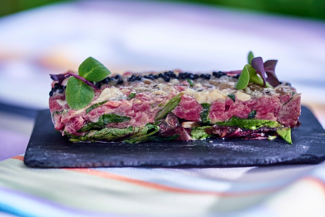 Beef tartare served on a slate plate