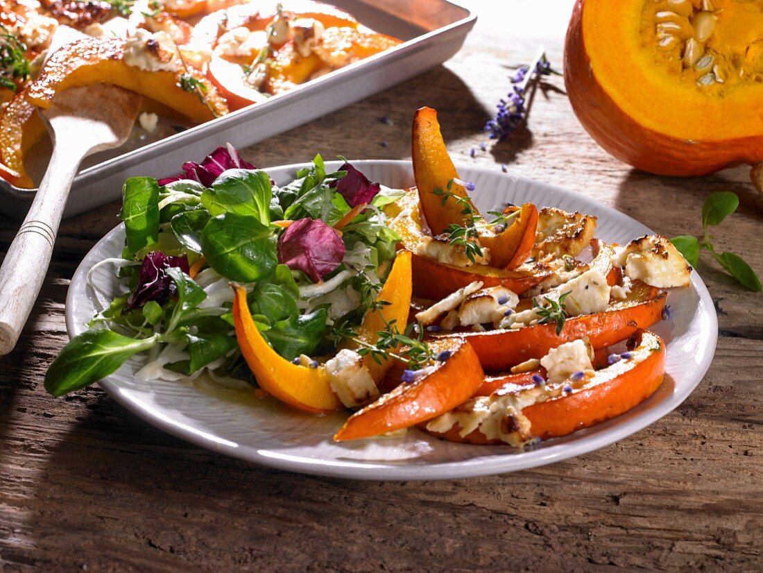 Oven-baked pumpkin wedges with feta and a side salad