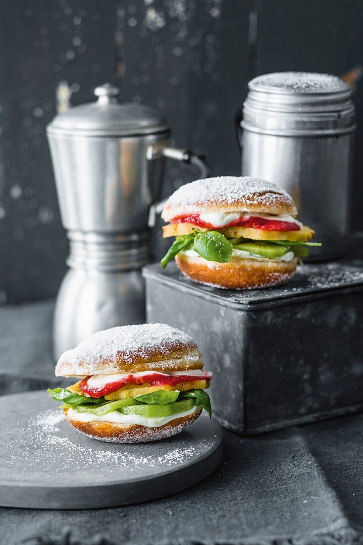 Sweet burgers: doughnuts with pineapple, kiwi, lime cream, raspberry sauce, and basil