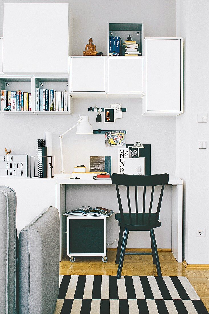 A workspace with open and closed shelves in a living room