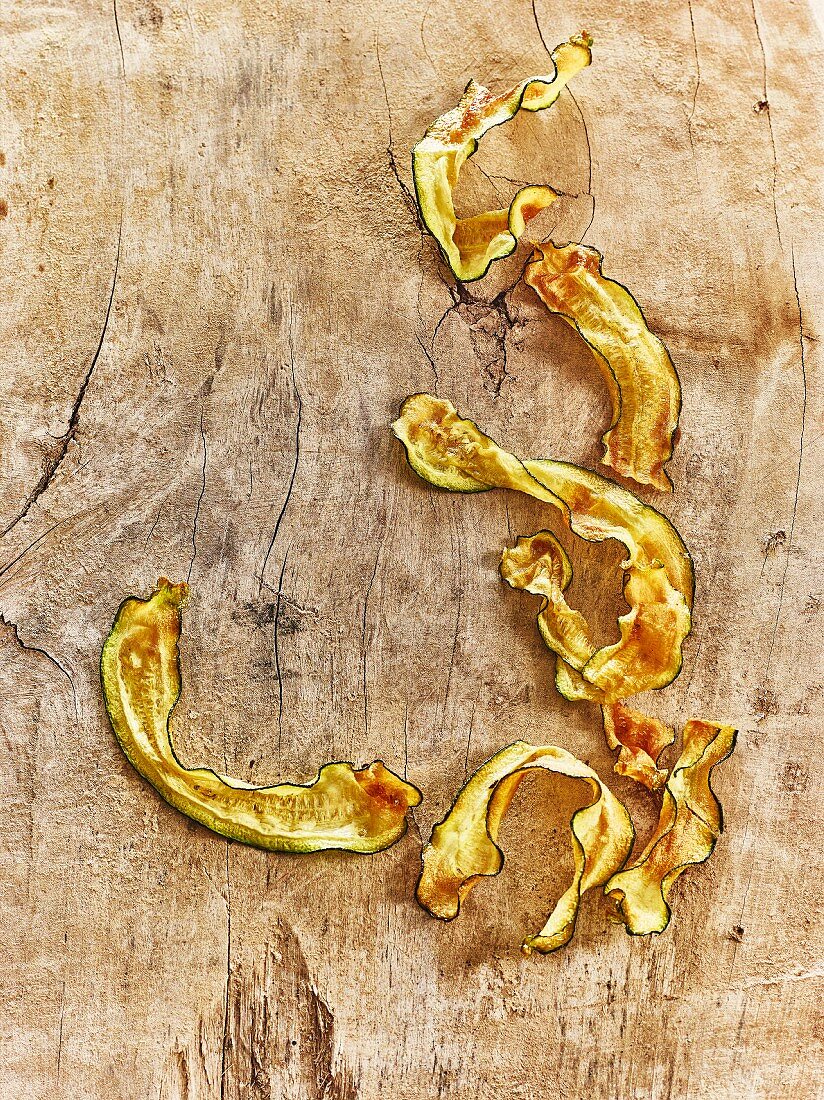 Fried courgette strips on a wooden background