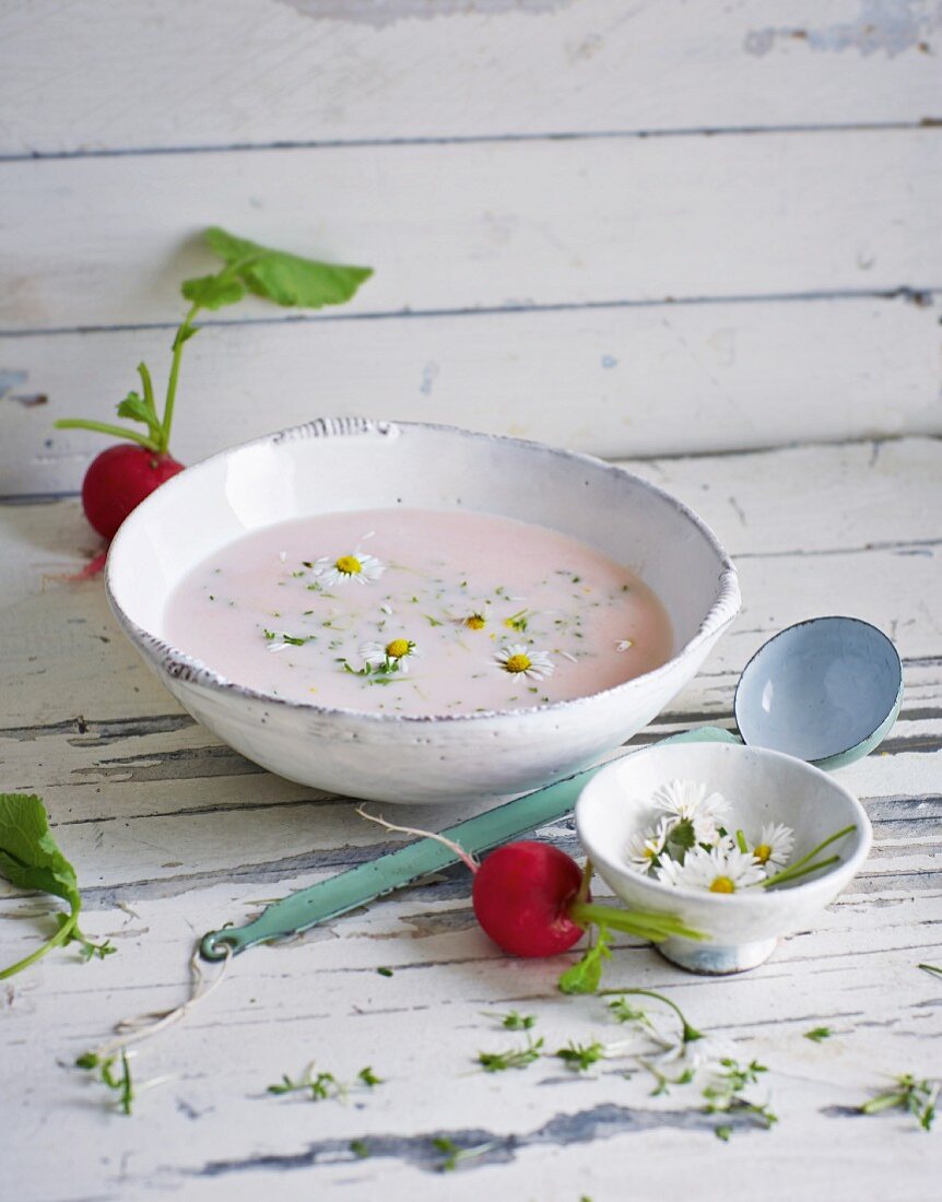 Pink radish soup with cress and wild flowers