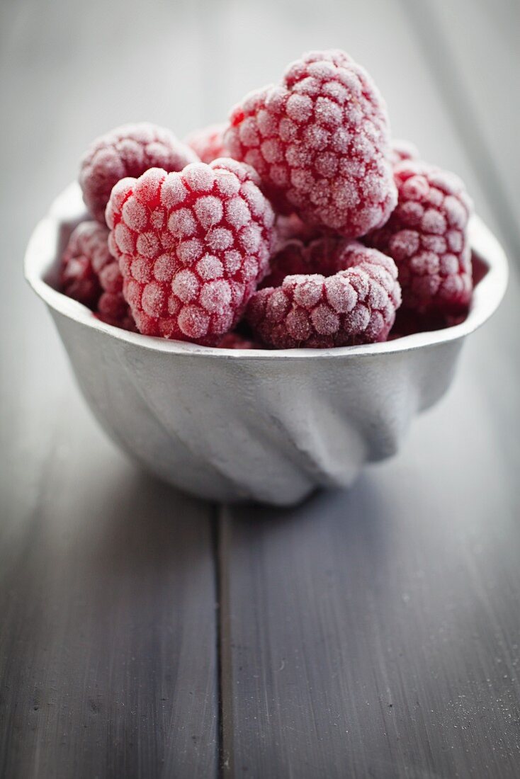 Vintage aluminium mould filled with frozen raspberries