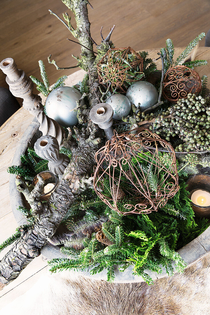 Wintry arrangement of pine twigs and dry branches in bowl