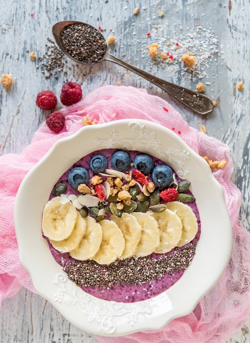 Berry smoothie bowl with bananas, chia, almonds and pumpkin seeds