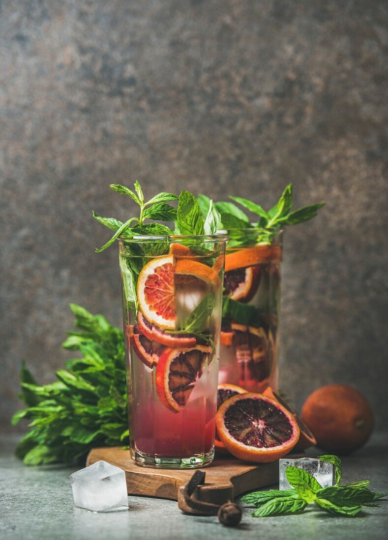 Blood orange citrus lemonade with mint and ice in tall glasses