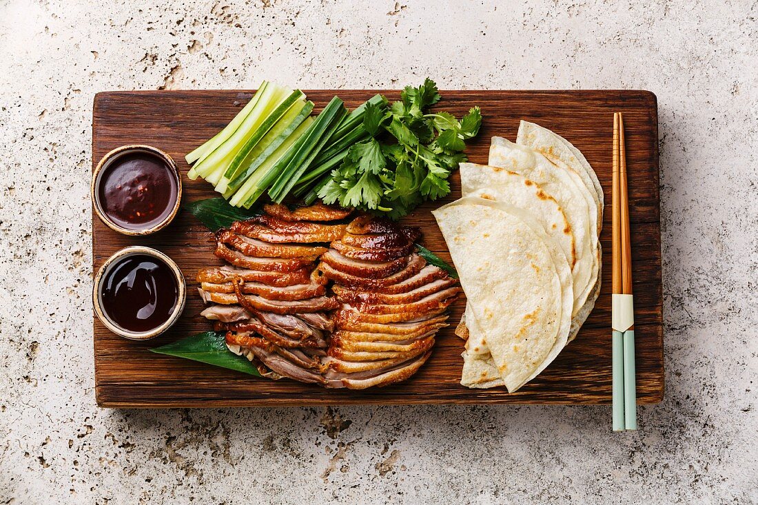 Peking Duck served with fresh cucumber, green onions, cilantro and roasted wheaten chinese pancakes