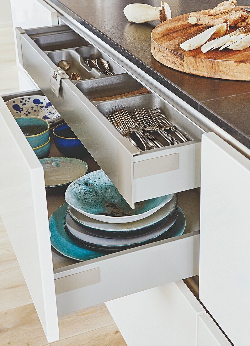 A kitchen island with open drawers