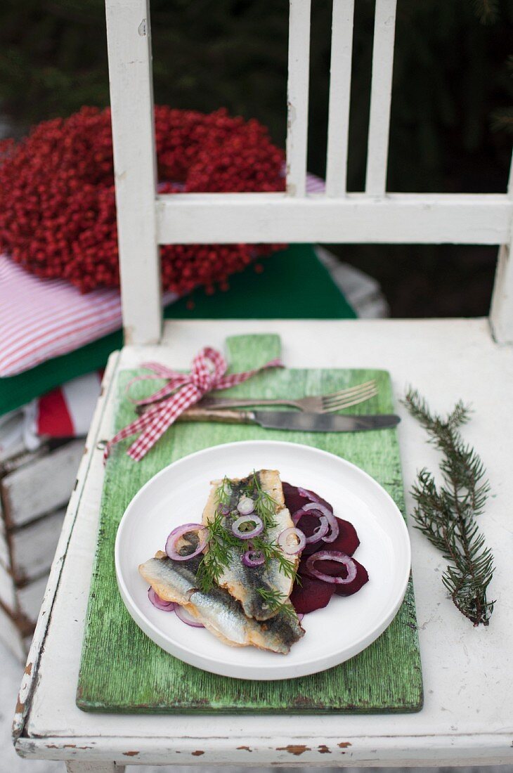 Fried herring served with roasted beet root, red onion and fresh dill