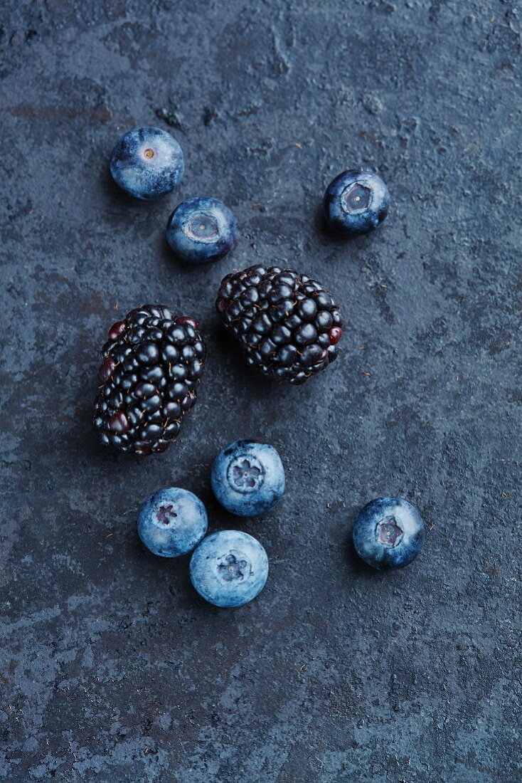 Blackberries and blueberries on a stone background