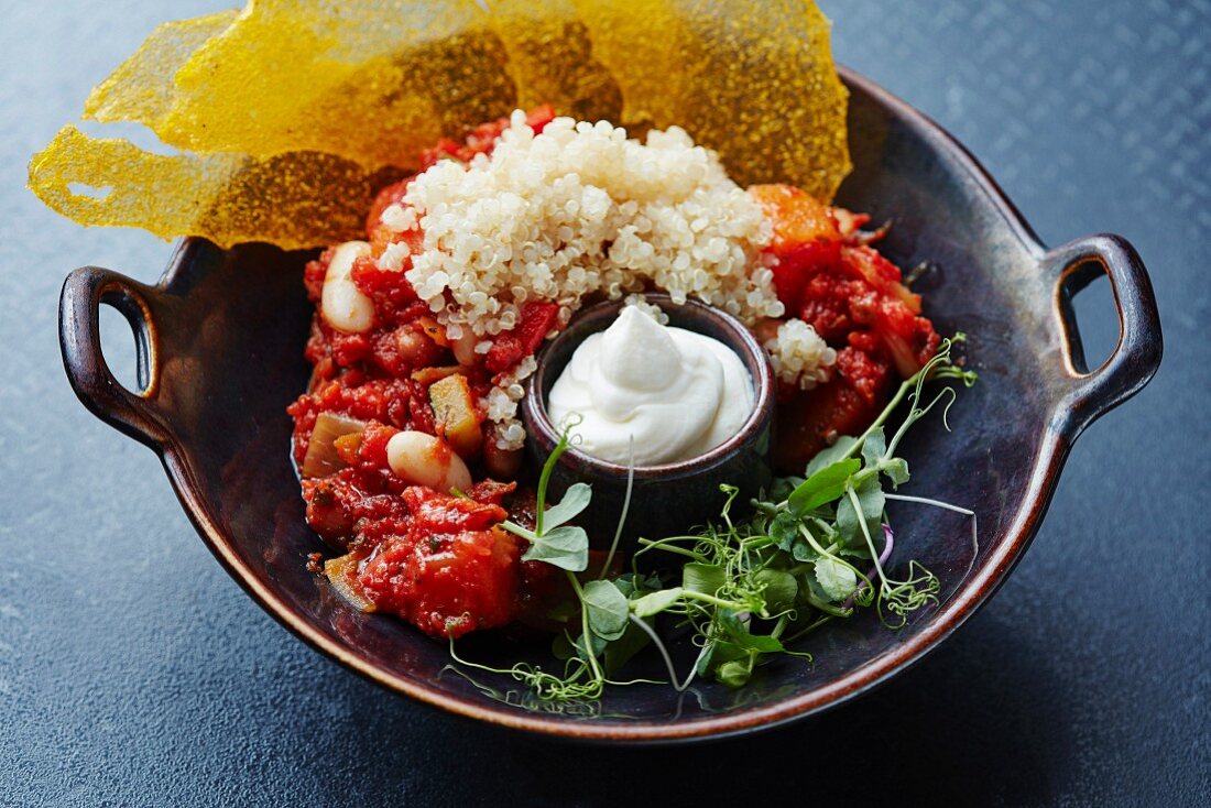 Tomato and bean stew with couscous and sour cream