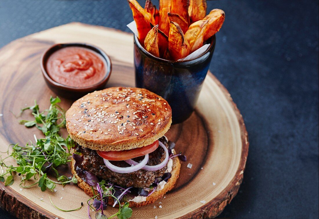 A hamburger with sweet potato fries